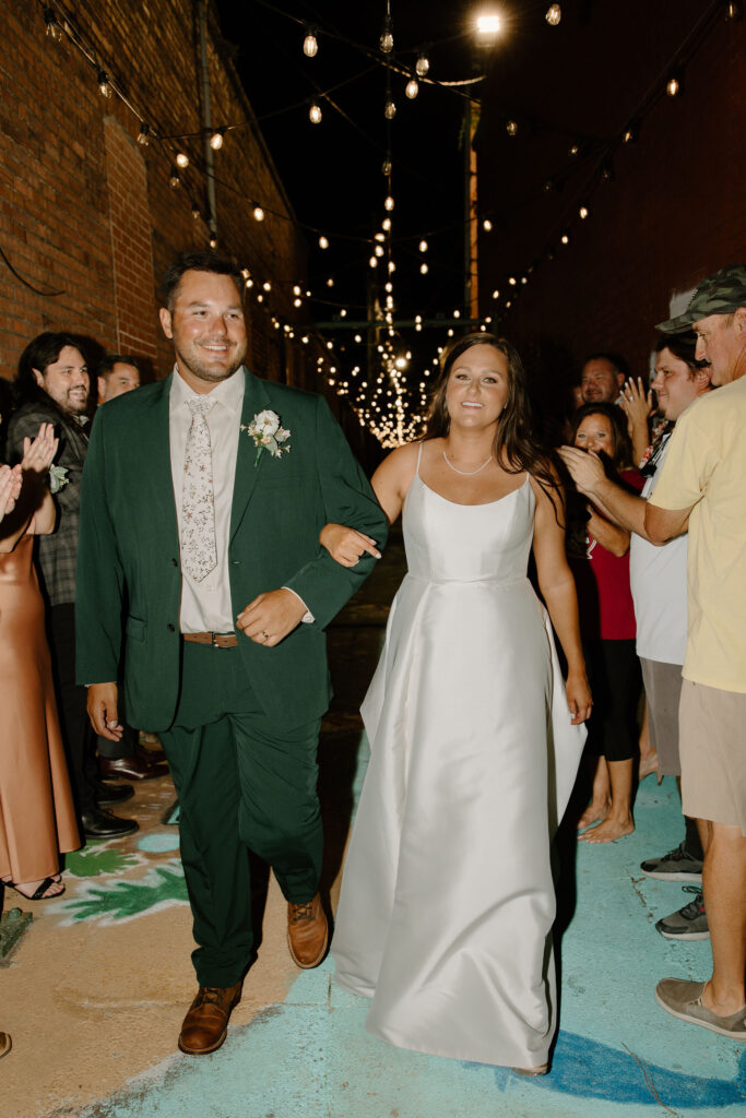 bride and groom walking down wedding exit