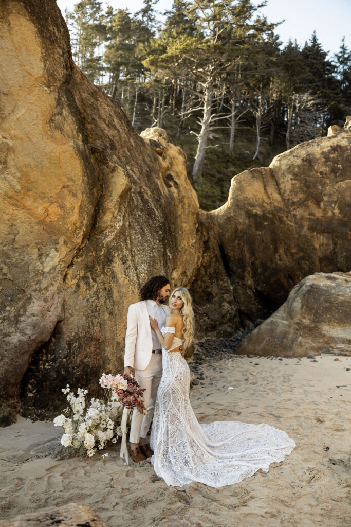 bride and groom posing for oregon coast elopement