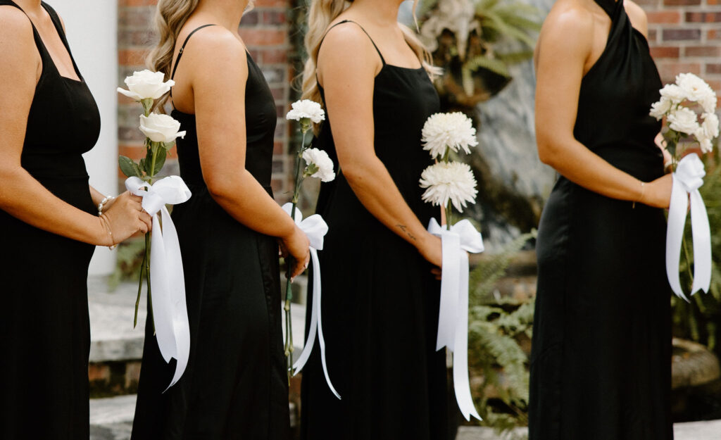 black bridesmaid dresses with white bouquet