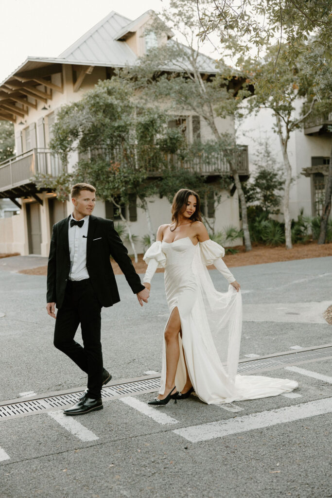 bride and groom walking across the street in 30A