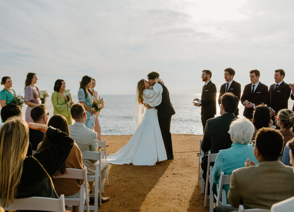 sunset cliffs wedding ceremony bride and groom kiss
