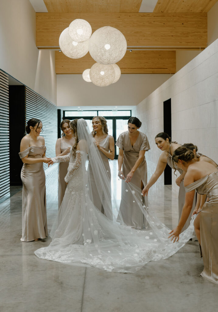 bridesmaids helping bride get ready for wedding ceremony